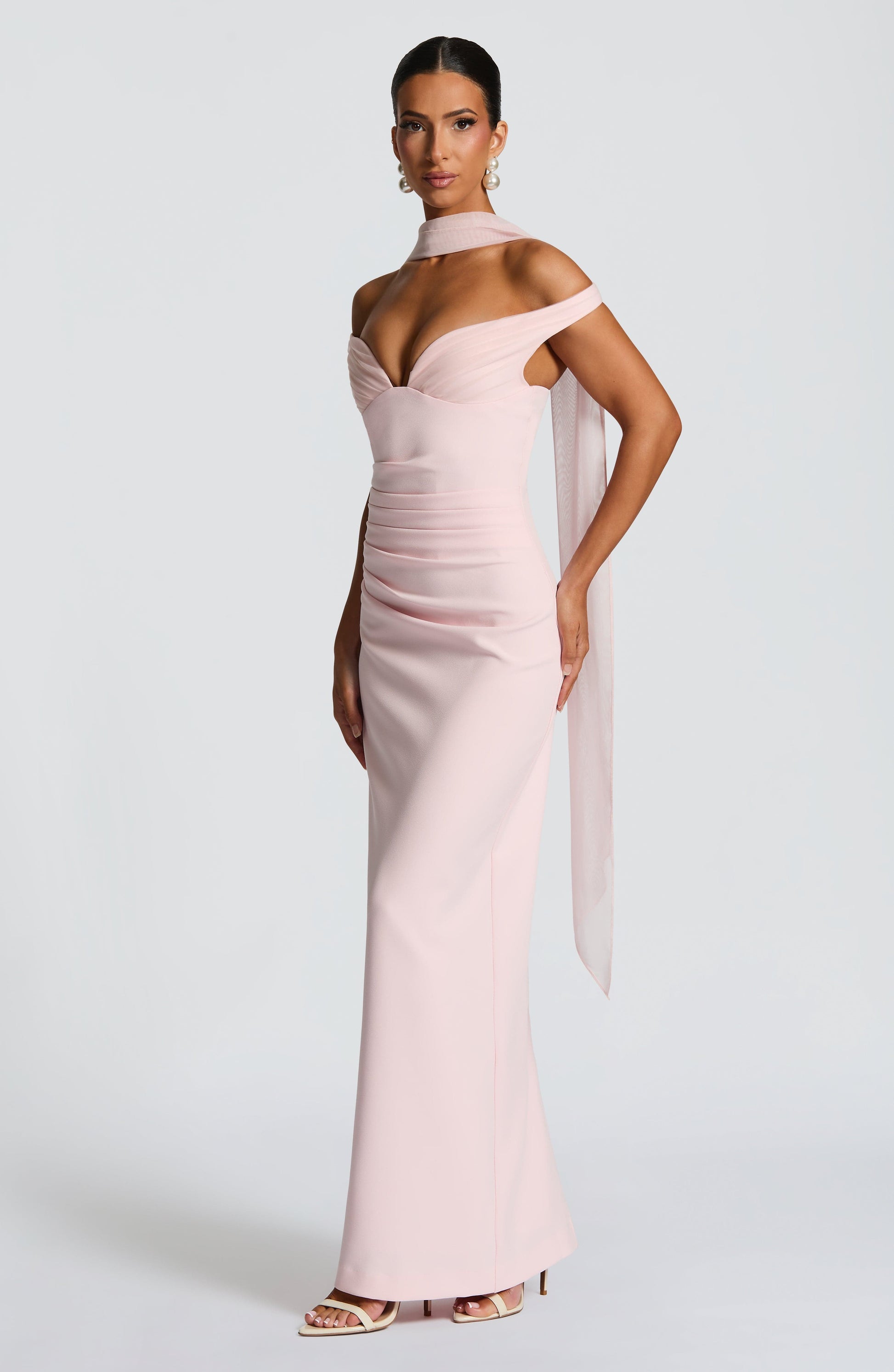 Woman wearing a pink evening gown on a white background