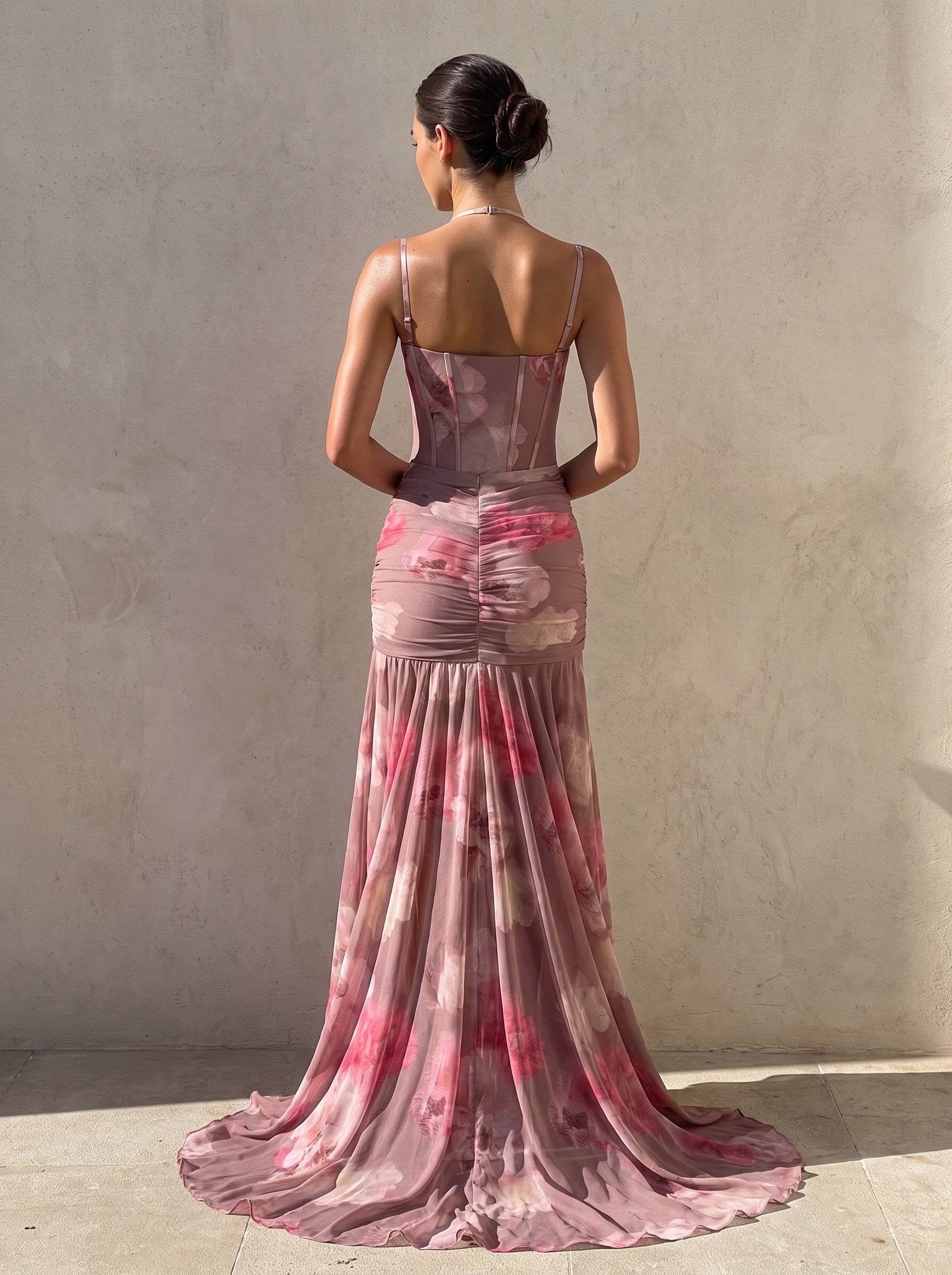 Back view of the blurred floral corset gown showing the boned panel seams, fine straps and the flaring fishtail skirt with a puddle train — SÉRAPHINE CORSET GOWN — Kalii