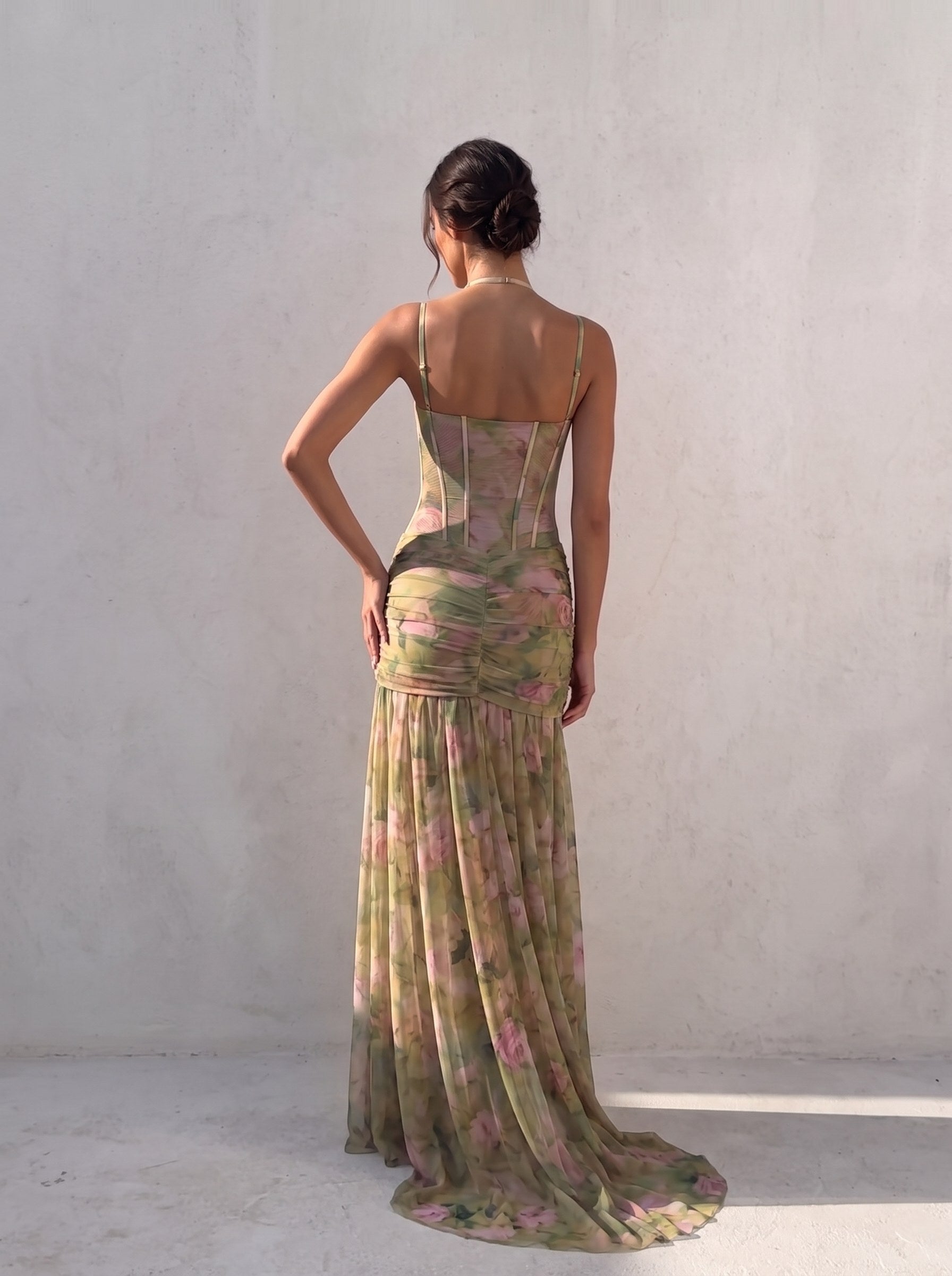 Back view of a sage green floral corset gown showing the closed low back, vertical boning and halter strap — SÉRAPHINE CORSET GOWN — Kalii