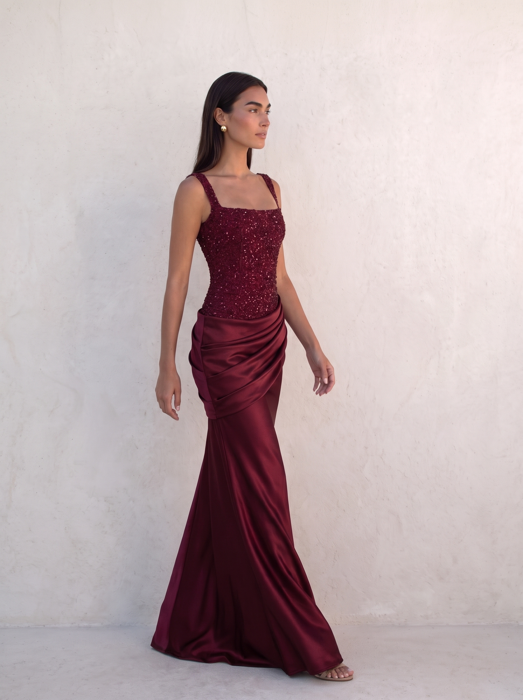 VESPERA BEADED GOWN in burgundy — walking, the satin column skirt moving with her step — Kalii