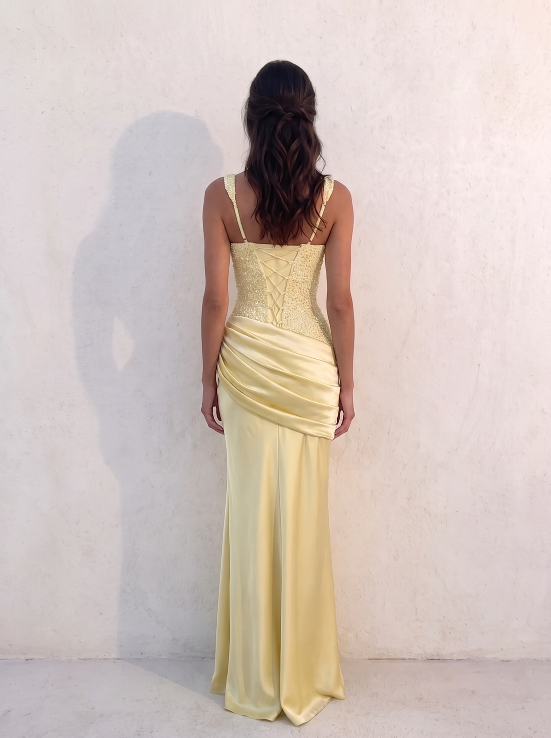 Back of the VESPERA BEADED GOWN in lemon — criss-cross ribbon lacing over the satin centre panel with beaded panels either side — Kalii